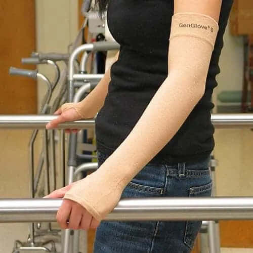 Person wearing a beige GeriGlove on their left arm