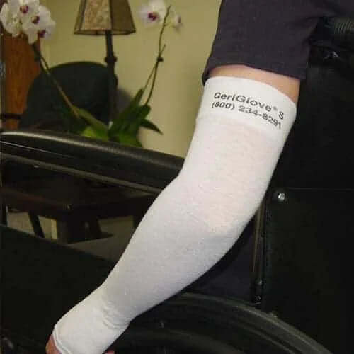 Person wearing a white GeriGlove on their left arm